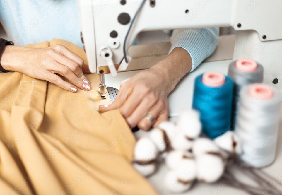 Workplace behind a sewing machine. Hand-sewn, organic sustainable fabrics.